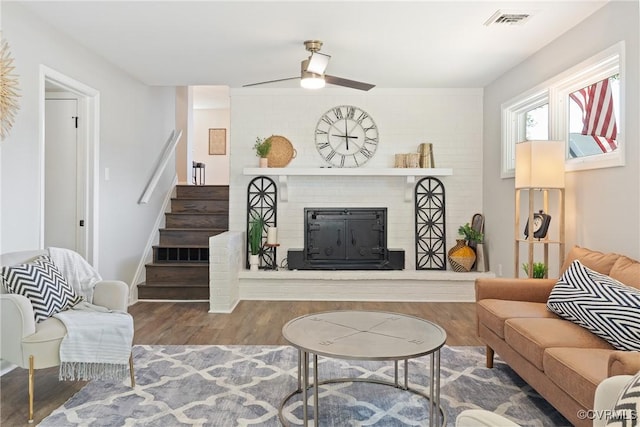 713 Chapman St, Ashland, VA 23005 - living room featuring wood finished floors, a fireplace, a ceiling fan, and stairs