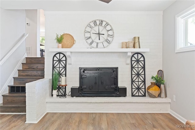 713 Chapman St, Ashland, VA 23005 - detailed view of wood finished floors, a brick fireplace, and baseboards