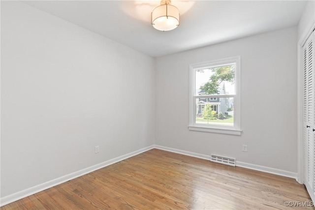 713 Chapman St, Ashland, VA 23005 - unfurnished bedroom featuring light wood-type flooring, a closet, and baseboards
