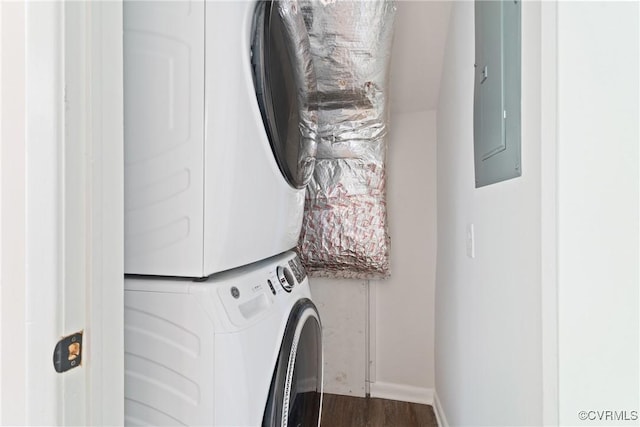 713 Chapman St, Ashland, VA 23005 - laundry room featuring stacked washer and clothes dryer, electric panel, dark wood-style flooring, and baseboards