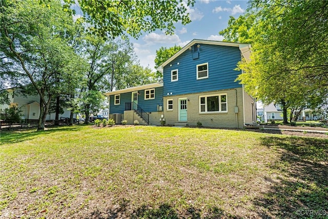 713 Chapman St, Ashland, VA 23005 - rear view of property featuring cooling unit, a yard, and brick siding