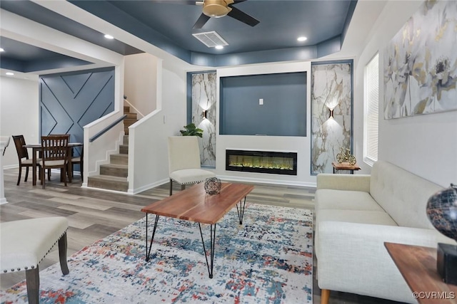 1114 Hinton St, Petersburg, VA 23803 - living area featuring wood finished floors, stairs, ceiling fan, a glass covered fireplace, and recessed lighting