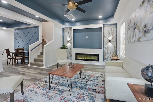 1114 Hinton St, Petersburg, VA 23803 - living area with wood finished floors, stairs, a ceiling fan, a glass covered fireplace, and recessed lighting