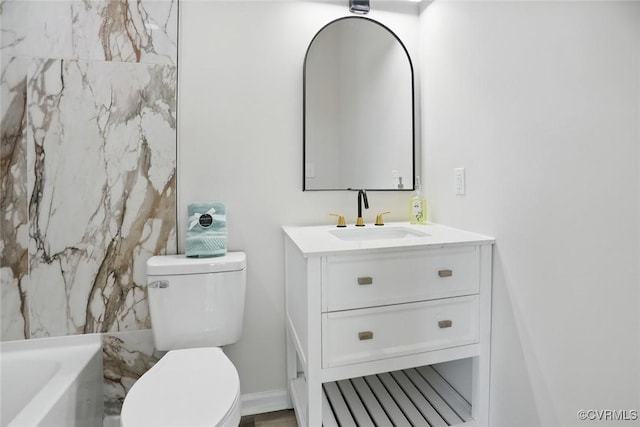 1114 Hinton St, Petersburg, VA 23803 - full bathroom with toilet, vanity, a bath, and baseboards