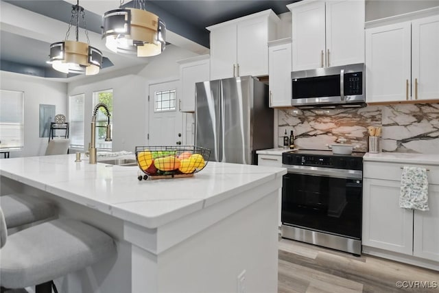 1114 Hinton St, Petersburg, VA 23803 - kitchen featuring stainless steel appliances, a sink, and white cabinetry