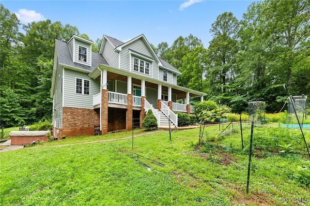 11021 Grub Hill Church Rd, Amelia Courthouse, VA 23002 - view of front of property with a hot tub, a porch, a front yard, and brick siding