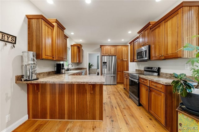11021 Grub Hill Church Rd, Amelia Courthouse, VA 23002 - kitchen with appliances with stainless steel finishes, brown cabinets, a peninsula, light wood-style flooring, and recessed lighting