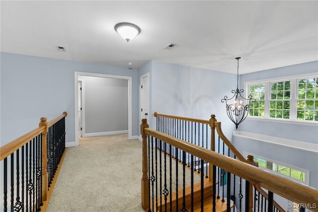 11021 Grub Hill Church Rd, Amelia Courthouse, VA 23002 - hallway with an upstairs landing, a chandelier, and light colored carpet