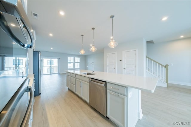 4302 Weaver Brook Rd Unit B, Glen Allen, VA 23233 - kitchen with appliances with stainless steel finishes, a sink, light wood finished floors, open floor plan, and light countertops