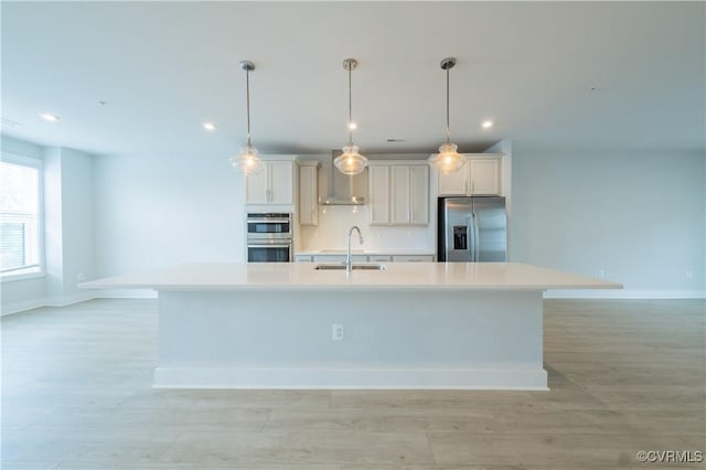 4302 Weaver Brook Rd Unit B, Glen Allen, VA 23233 - kitchen featuring stainless steel appliances, wall chimney range hood, a large island with sink, a sink, and light countertops
