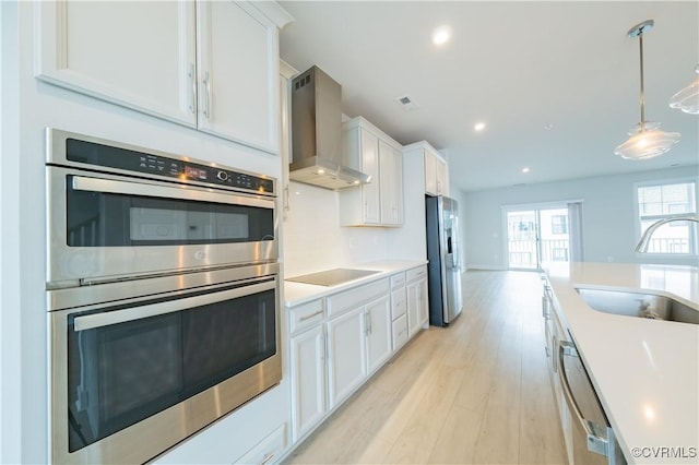 4302 Weaver Brook Rd Unit B, Glen Allen, VA 23233 - kitchen featuring stainless steel appliances, wall chimney range hood, a sink, white cabinetry, and recessed lighting