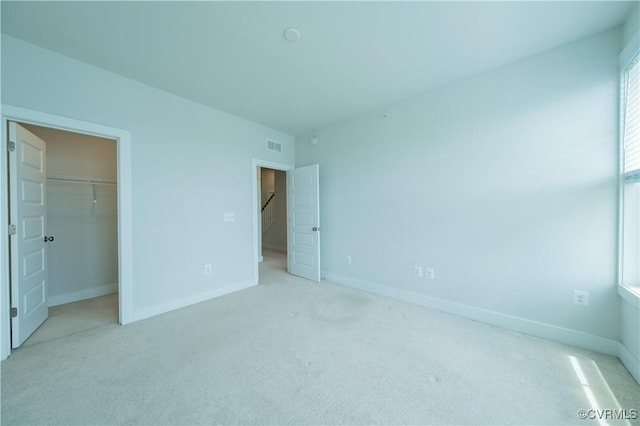 4302 Weaver Brook Rd Unit B, Glen Allen, VA 23233 - unfurnished bedroom featuring light colored carpet, a walk in closet, baseboards, and a closet