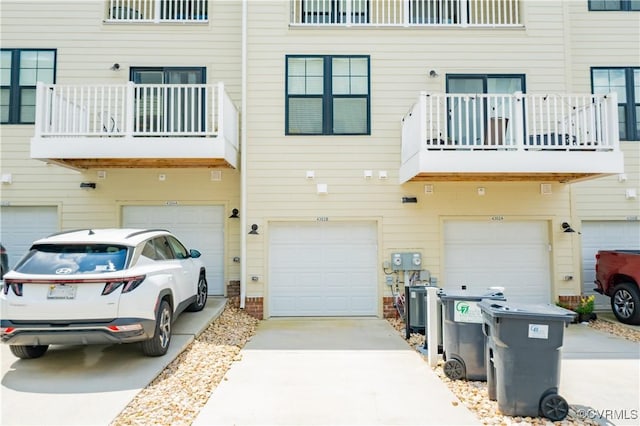4302 Weaver Brook Rd Unit B, Glen Allen, VA 23233 - rear view of house with a balcony, an attached garage, and driveway