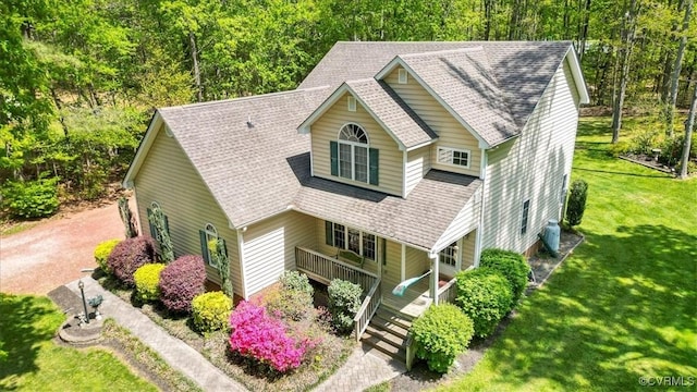 2024 Judes Ferry Rd, Powhatan, VA 23139 - view of front facade featuring covered porch, roof with shingles, a front lawn, and a wooded view