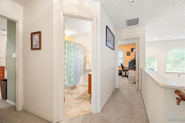 2024 Judes Ferry Rd, Powhatan, VA 23139 - hallway featuring light carpet, a desk, and a textured ceiling