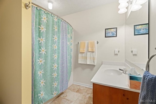 2024 Judes Ferry Rd, Powhatan, VA 23139 - bathroom with vanity, stone finish flooring, baseboards, a chandelier, and a textured ceiling