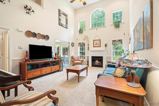 2024 Judes Ferry Rd, Powhatan, VA 23139 - living area with a high ceiling, ceiling fan, healthy amount of natural light, carpet, and a lit fireplace