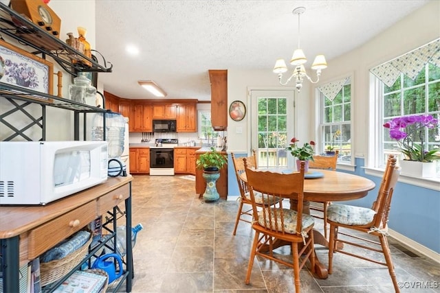 2024 Judes Ferry Rd, Powhatan, VA 23139 - dining space featuring a chandelier, a textured ceiling, and baseboards
