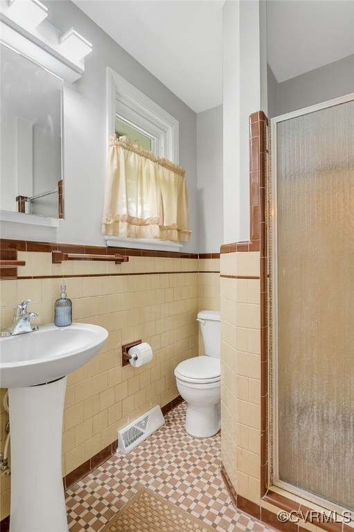 3304 Walnut St, Hopewell, VA 23860 - full bath with tile walls, a shower stall, a wainscoted wall, and tile patterned floors
