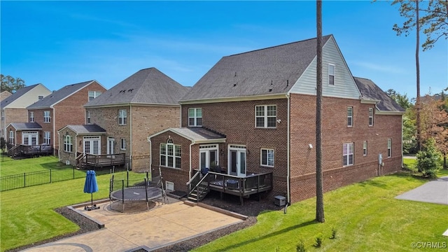 5217 Aldenbrook Way, Henrico, VA 23059 - back of property featuring a trampoline, a wooden deck, a patio area, and brick siding