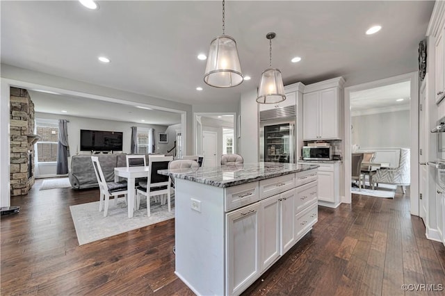 5217 Aldenbrook Way, Henrico, VA 23059 - kitchen featuring stainless steel appliances, white cabinets, dark wood-type flooring, light stone counters, and a kitchen island