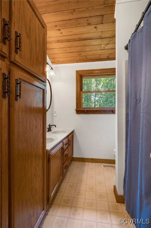 4285 Hadensville Farm Rd, Goochland, VA 23117 - bathroom featuring wooden ceiling, double vanity, and tile patterned floors