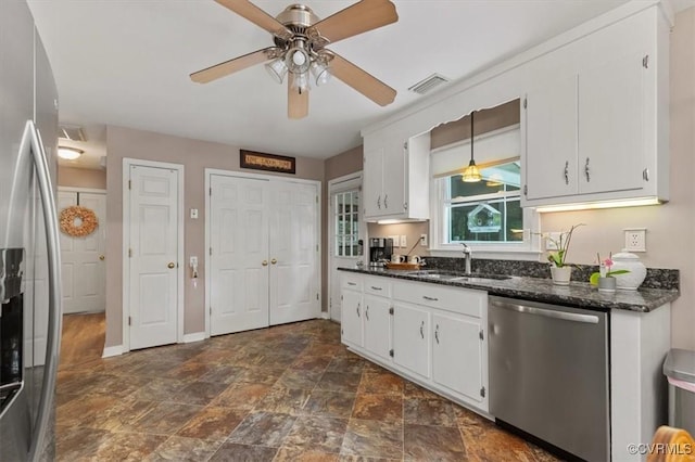 7503 Native Dancer Dr, Midlothian, VA 23112 - kitchen with stainless steel appliances, a sink, white cabinetry, and dark stone finish flooring