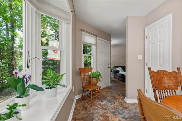 7503 Native Dancer Dr, Midlothian, VA 23112 - doorway with baseboards and dark stone finish floors