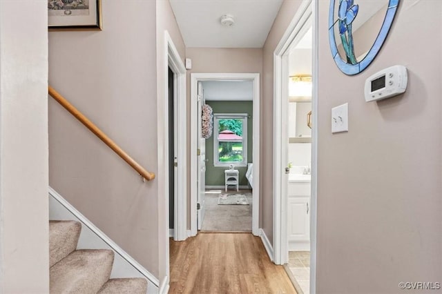 7503 Native Dancer Dr, Midlothian, VA 23112 - hall featuring light wood-style flooring, baseboards, and a sink