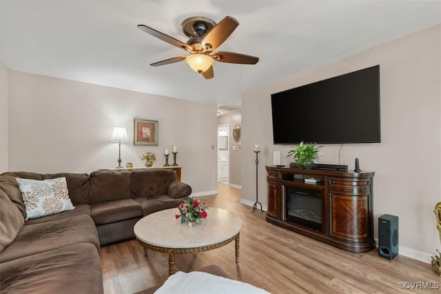 7503 Native Dancer Dr, Midlothian, VA 23112 - living area with light wood finished floors, ceiling fan, and baseboards