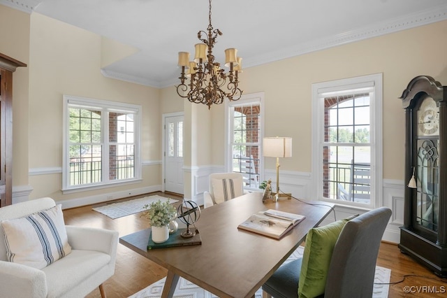 12316 Traylor Field Ln, Ashland, VA 23005 - dining area featuring a chandelier, healthy amount of natural light, wainscoting, wood finished floors, and crown molding