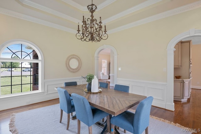 12316 Traylor Field Ln, Ashland, VA 23005 - dining space featuring arched walkways, wood finished floors, a wainscoted wall, ornamental molding, and a chandelier
