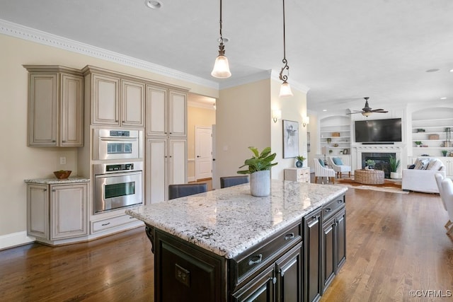 12316 Traylor Field Ln, Ashland, VA 23005 - kitchen featuring ceiling fan, a glass covered fireplace, a center island, light stone counters, and cream cabinets