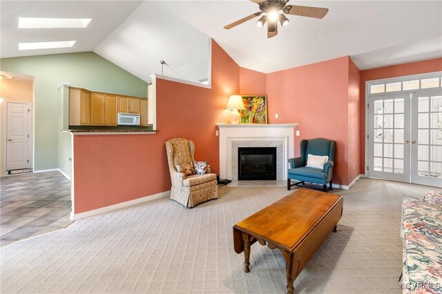 9401 Nolandwood Dr, Mechanicsville, VA 23116 - living room with lofted ceiling, light colored carpet, a ceiling fan, a skylight, and baseboards