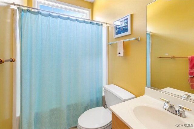 9401 Nolandwood Dr, Mechanicsville, VA 23116 - bathroom featuring toilet, vanity, and a shower with shower curtain