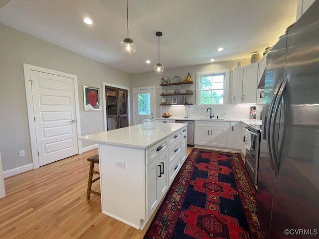 1710 N 29th St, Richmond, VA 23223 - kitchen featuring appliances with stainless steel finishes, open shelves, light countertops, recessed lighting, and white cabinets