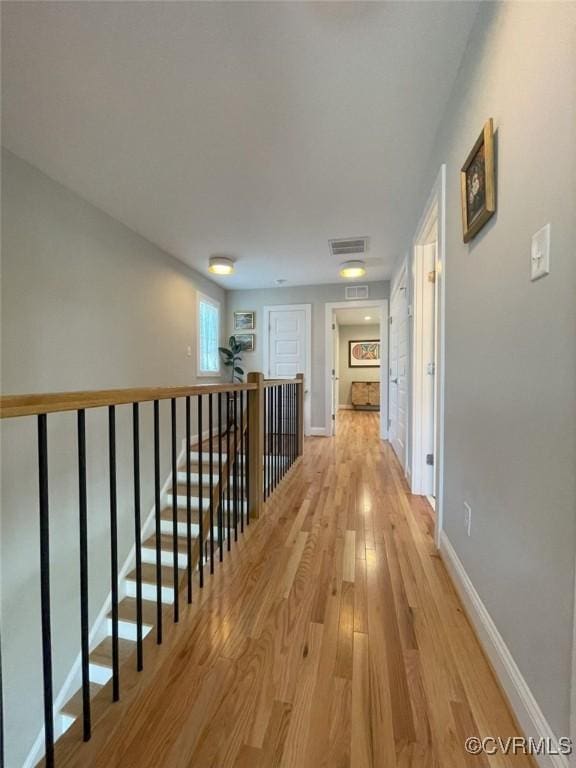 1710 N 29th St, Richmond, VA 23223 - corridor with light wood-style flooring, baseboards, and an upstairs landing