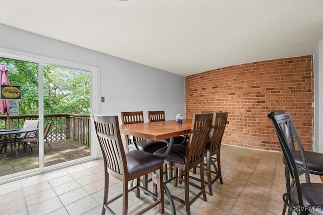 2911 Ennismore Ct, Chesterfield, VA 23224 - dining space with brick wall, light tile patterned floors, and an accent wall