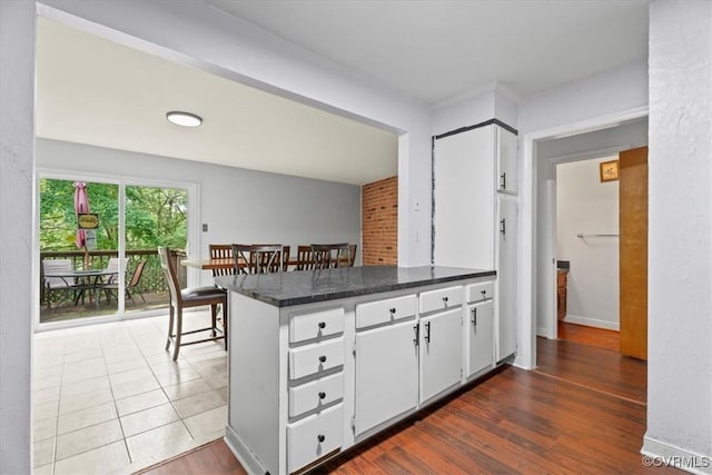 2911 Ennismore Ct, Chesterfield, VA 23224 - kitchen featuring a peninsula, white cabinetry, and dark wood-style floors