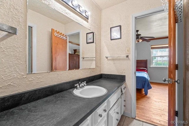 2911 Ennismore Ct, Chesterfield, VA 23224 - ensuite bathroom featuring a textured wall, vanity, ceiling fan, tile patterned flooring, and a textured ceiling