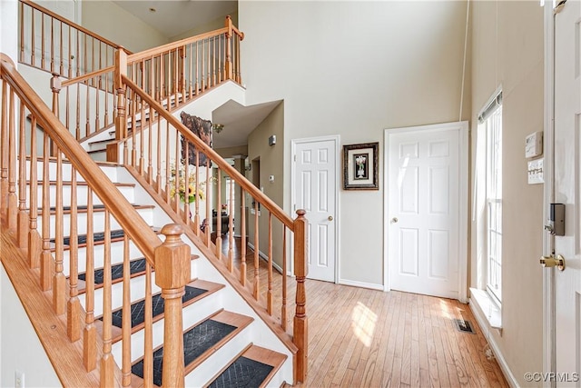 1408 Selma Ln, Henrico, VA 23223 - staircase featuring a high ceiling, hardwood / wood-style floors, and baseboards
