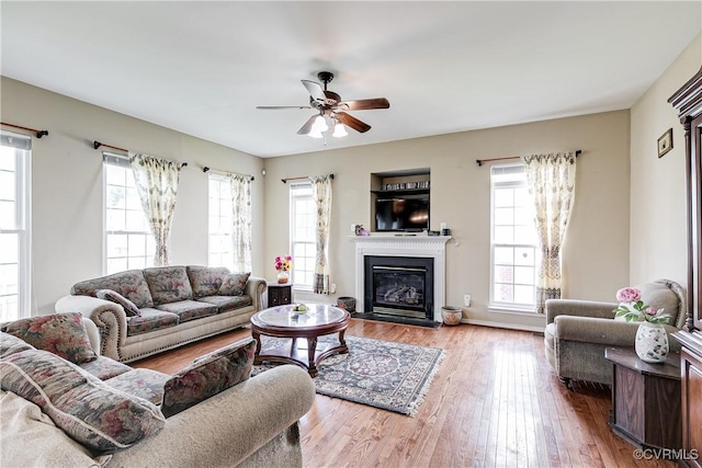 1408 Selma Ln, Henrico, VA 23223 - living room with a ceiling fan, a glass covered fireplace, and wood finished floors