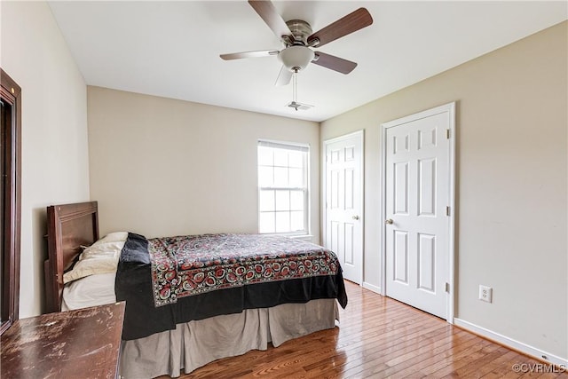 1408 Selma Ln, Henrico, VA 23223 - bedroom with wood-type flooring, baseboards, a ceiling fan, and multiple closets