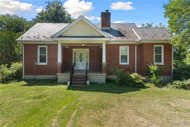672 Main St, Dillwyn, VA 23936 - view of front of property featuring a chimney, a front yard, and brick siding