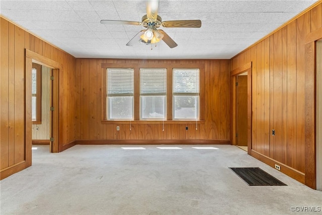 672 Main St, Dillwyn, VA 23936 - spare room featuring light colored carpet, ceiling fan, wooden walls, and baseboards