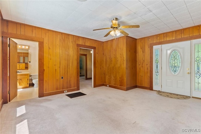 672 Main St, Dillwyn, VA 23936 - foyer featuring wood walls, ceiling fan, and carpet flooring