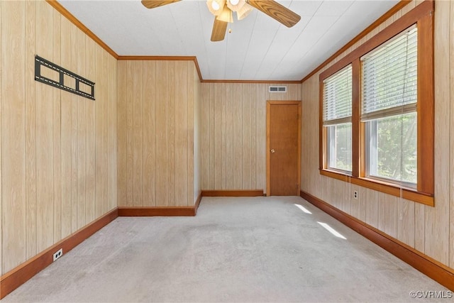 672 Main St, Dillwyn, VA 23936 - empty room featuring ornamental molding, carpet floors, a ceiling fan, baseboards, and wooden walls
