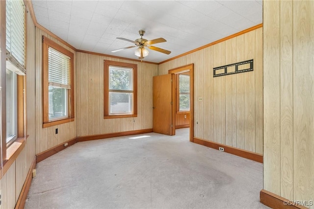 672 Main St, Dillwyn, VA 23936 - carpeted empty room with ornamental molding, a ceiling fan, baseboards, and wood walls