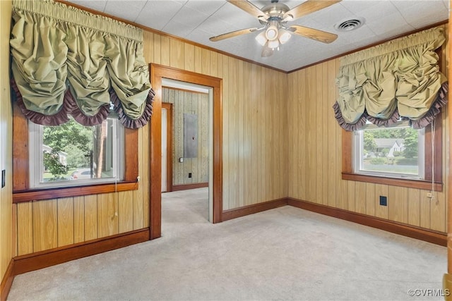 672 Main St, Dillwyn, VA 23936 - carpeted spare room featuring ornamental molding, baseboards, wood walls, and a ceiling fan