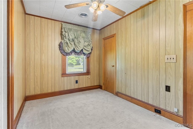 672 Main St, Dillwyn, VA 23936 - empty room with carpet, ceiling fan, wood walls, baseboards, and crown molding